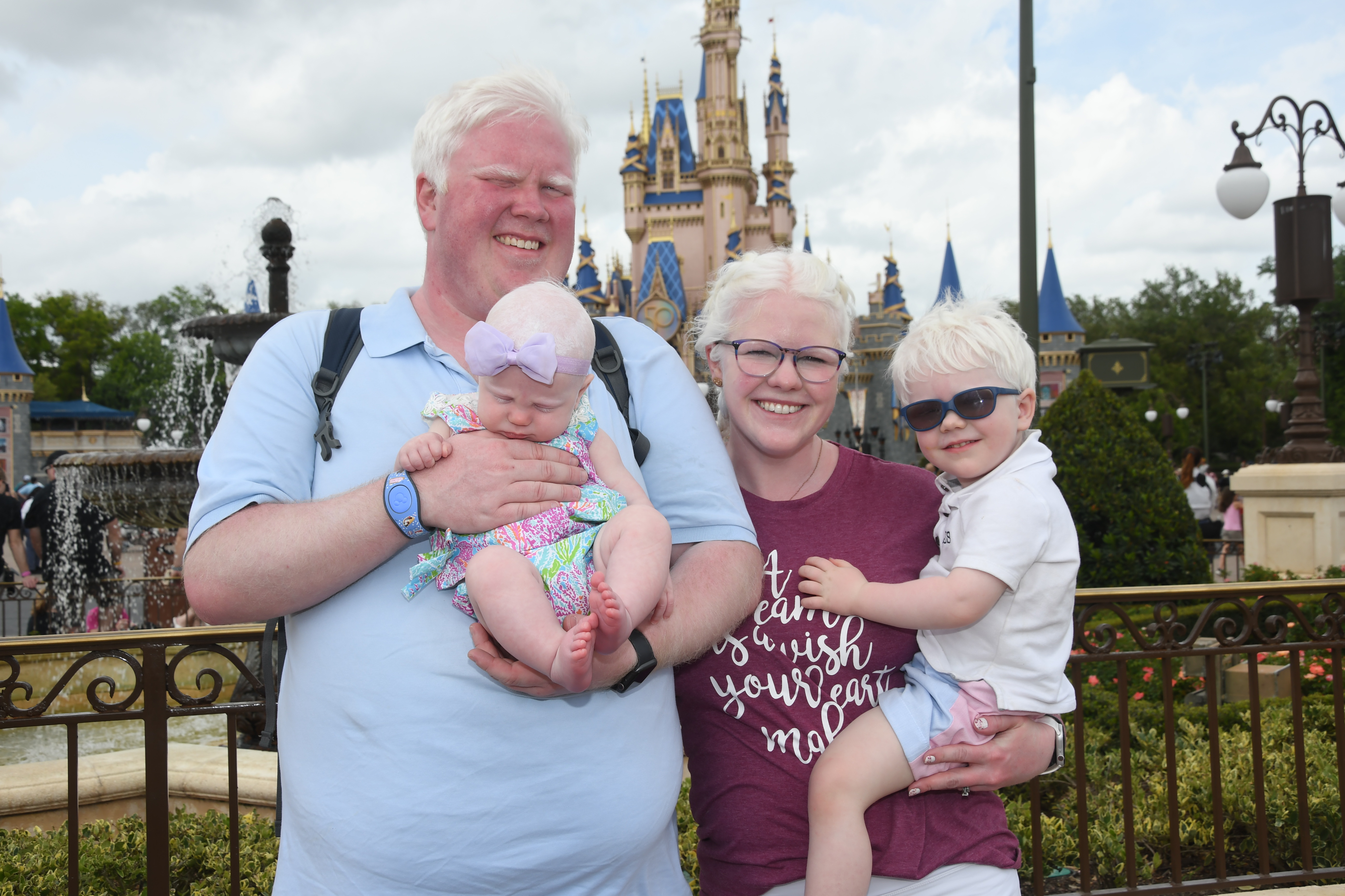 Andrew, Katherine, AJ, and Charlotte in front of the castle at Magic Kingdom